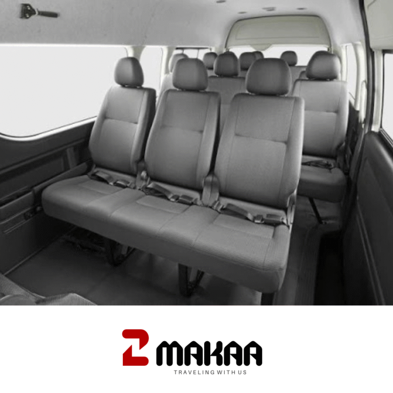Sewa Hiace Depok: Toyota Hiace putih melaju di jalanan kota Depok.